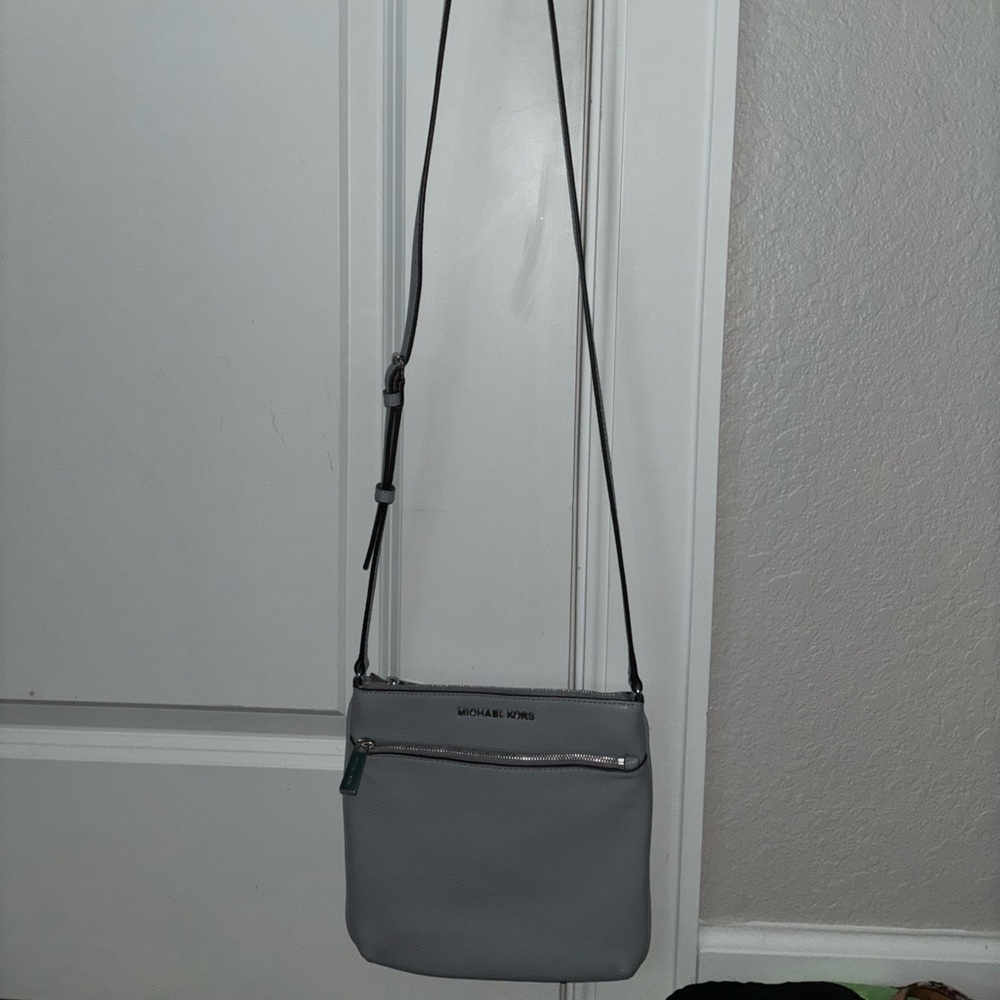 Michael Kors purse. Never worn or used. Has front pocket and adjustable straps.